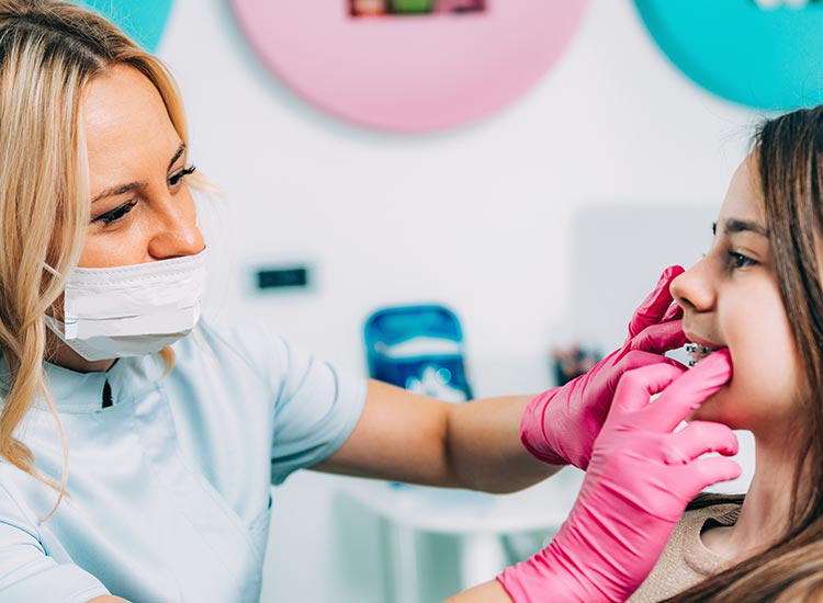 dentist checking patients braces