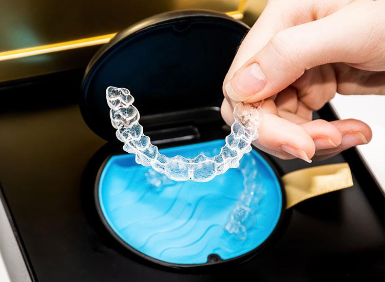person holding Invisalign
