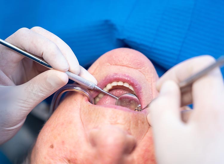 dentist checking patients teeth