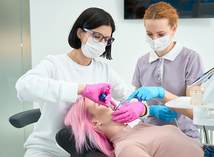 dentist and dental assistant working on patient