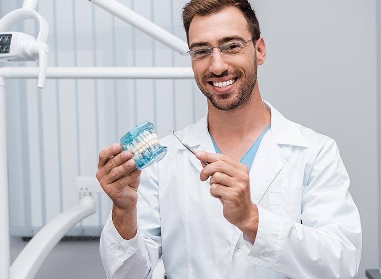 dentist smiling with dental tools