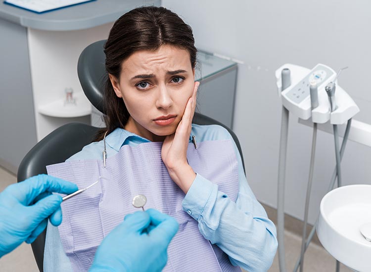 patient at dentist office having a toothache