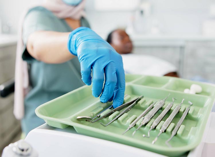 dentist grabbing dental tools