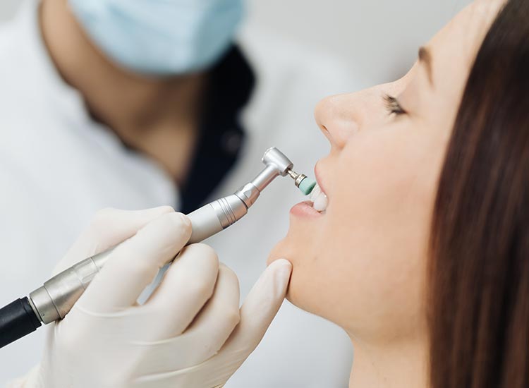 dentist performing a cleaning on patient