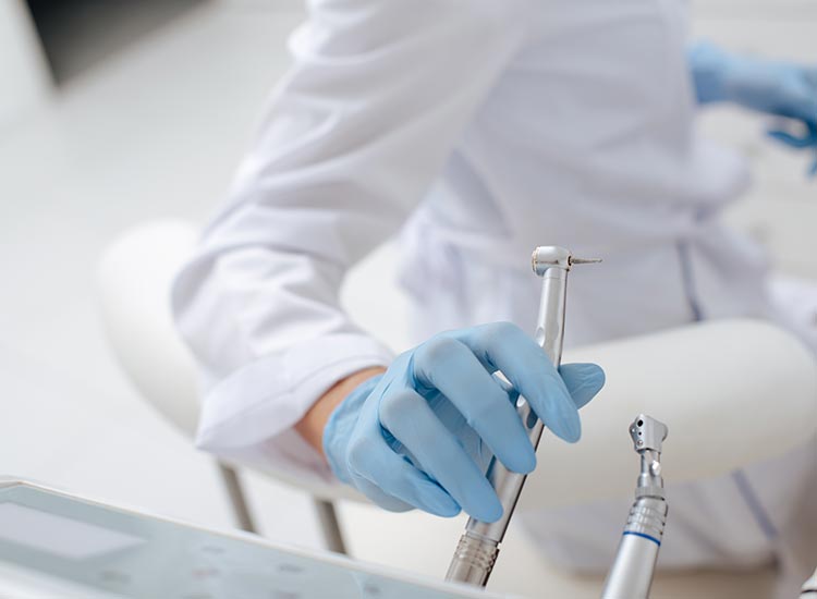 dentist grabbing dental tool