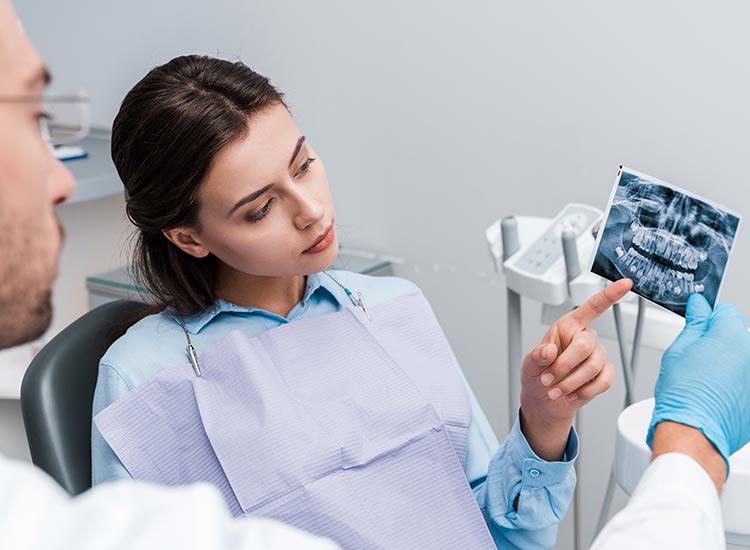 dentist examining x-ray with patient