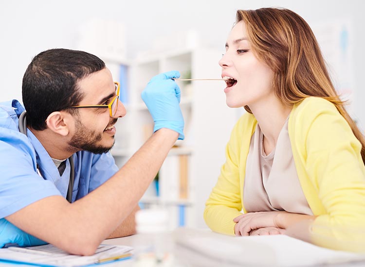 dental assistant checking patients mouth