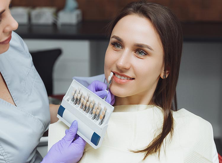 dentist showing dental veneer options to patient