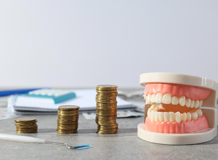 stack of coins and a mouth model