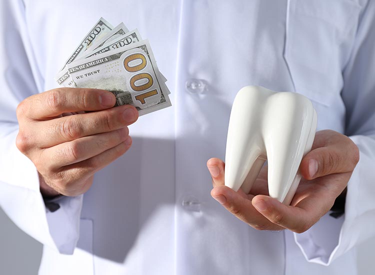 person holding money and a tooth