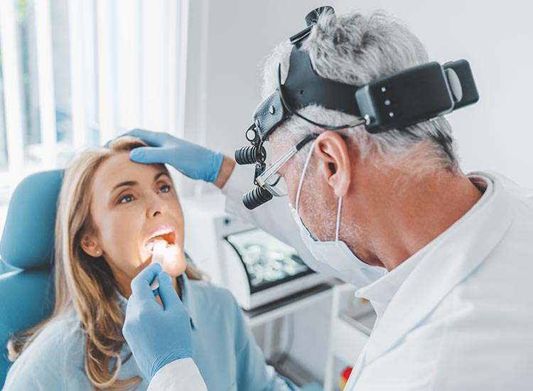 dentist getting a closer look at patients teeth