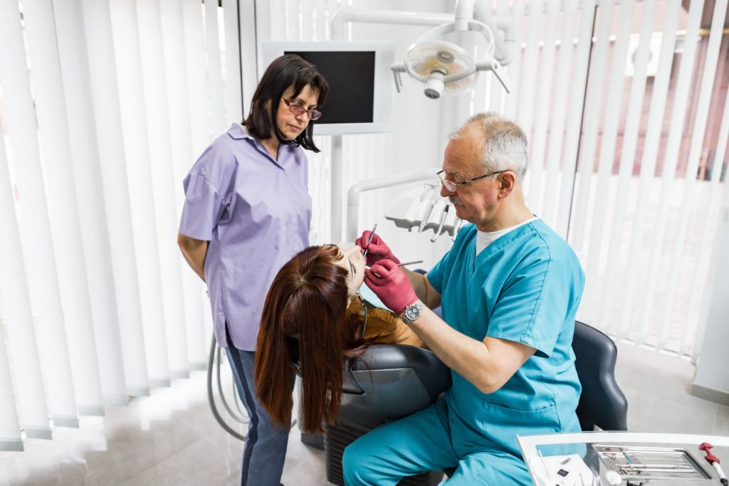 dentist performing a dental exam on patient