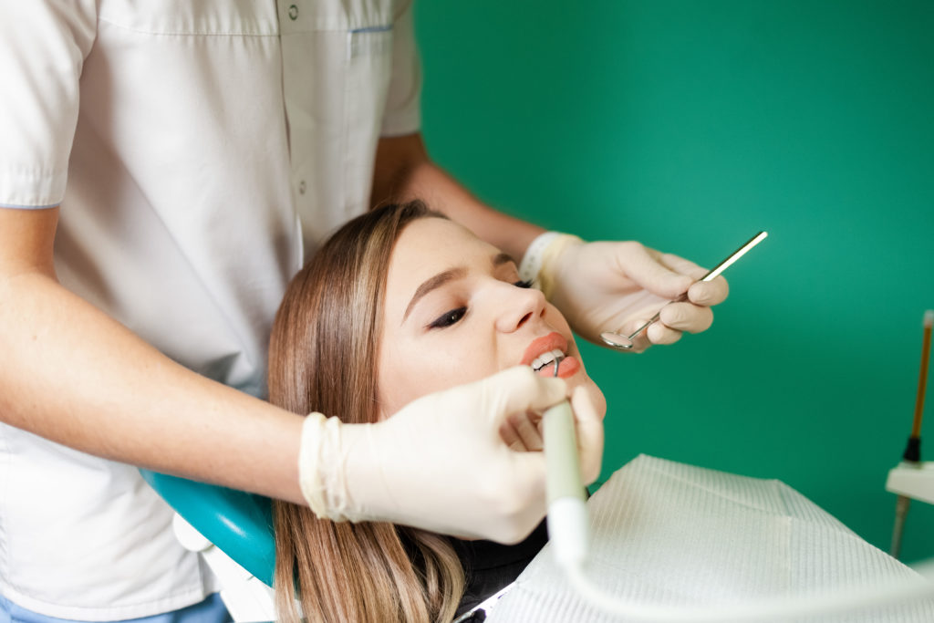 dental assistant working on patient
