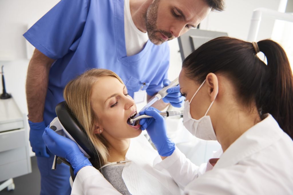dentist performing a root canal on patient