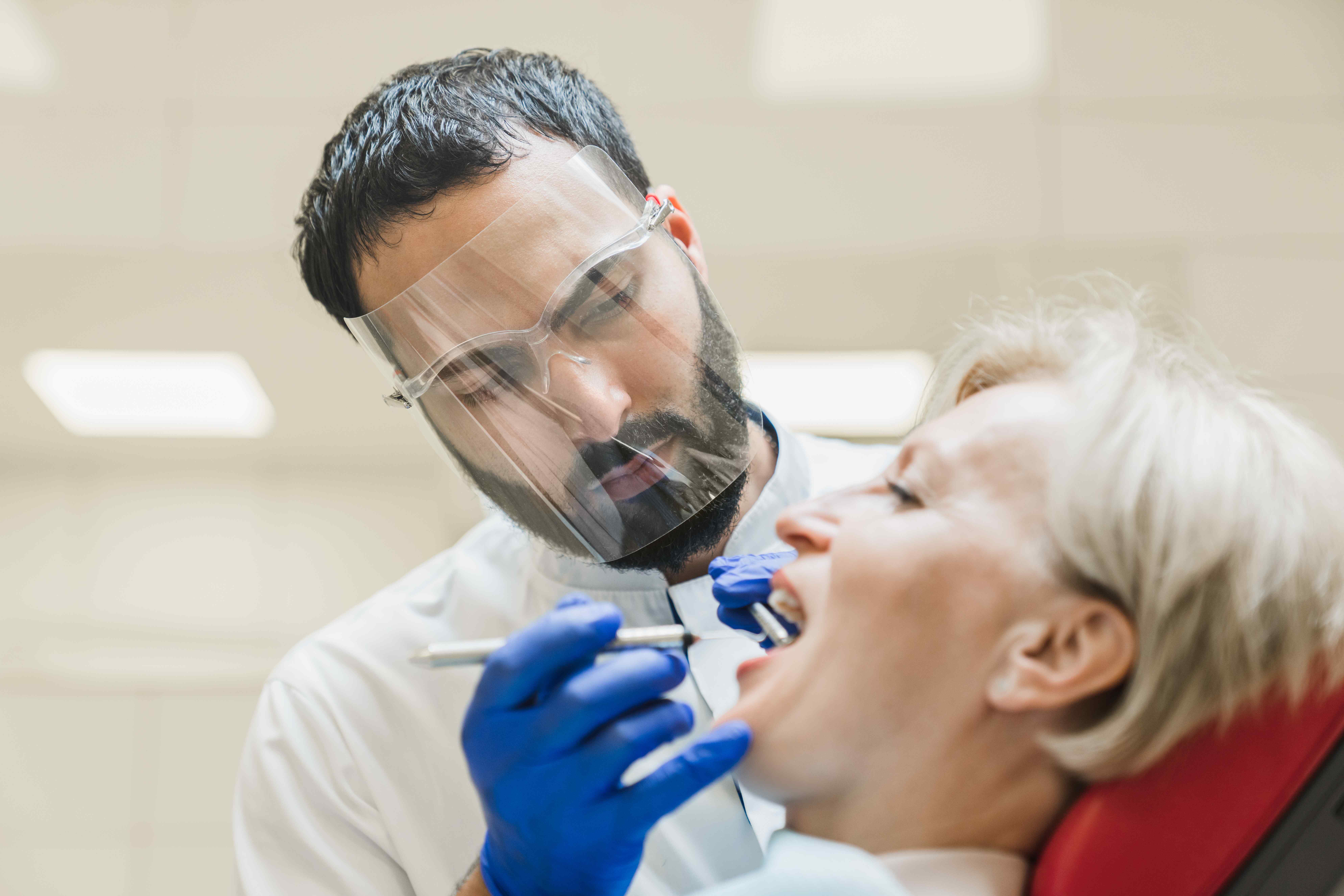 dentist performing oral health checkup