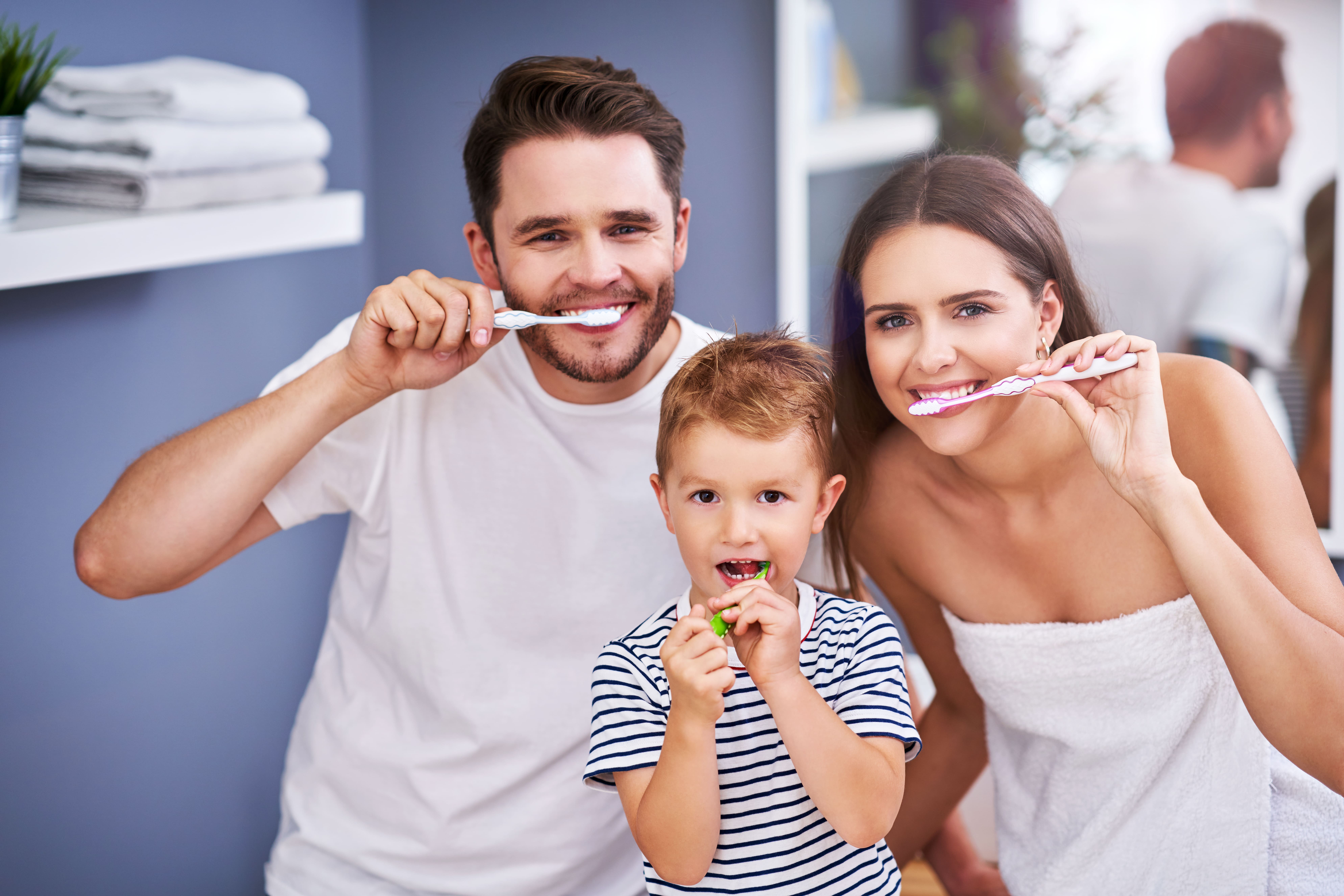 family brushing teeth together