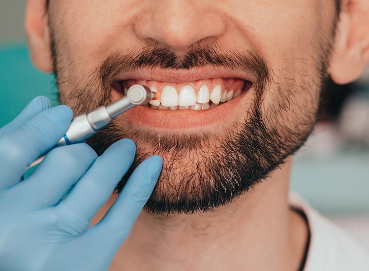 patient smiling with dental tools
