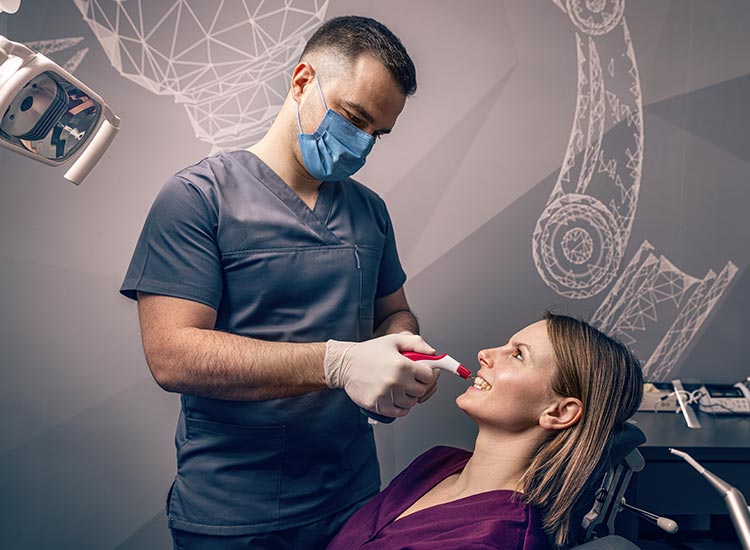 dentist performing cosmetic treatment