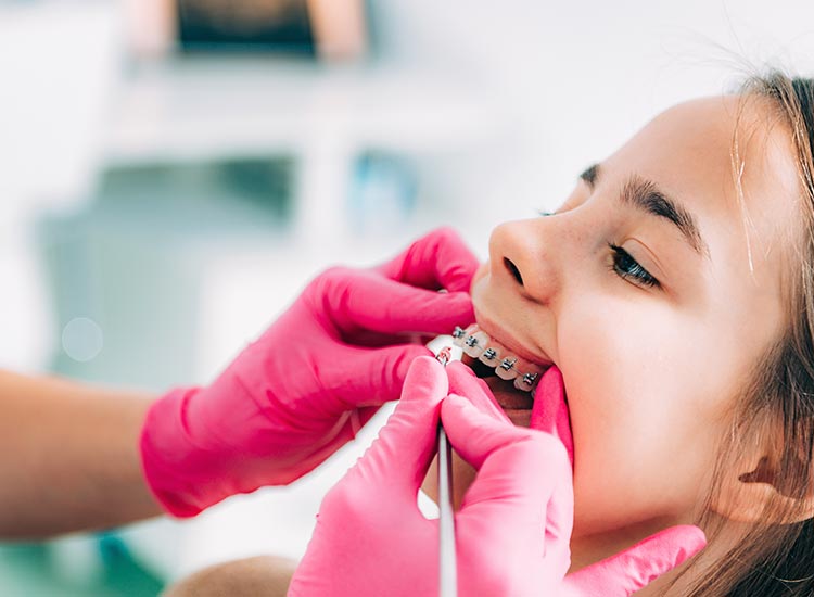dentist working on child's braces