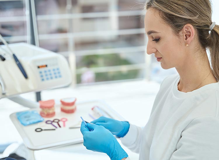 dental assistant prepping dental tools