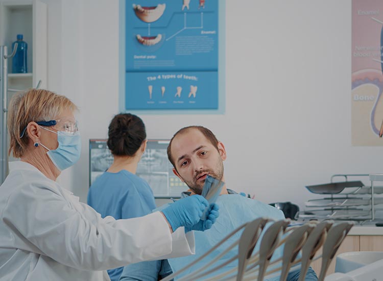 dentist showing x-ray to patient