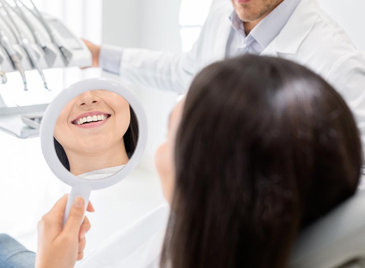 patient checking her new smile