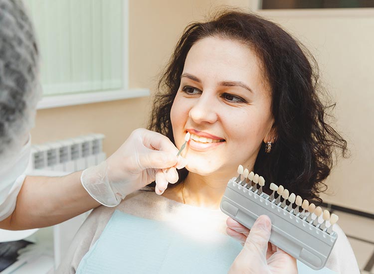 dentist showing veneer color to patient
