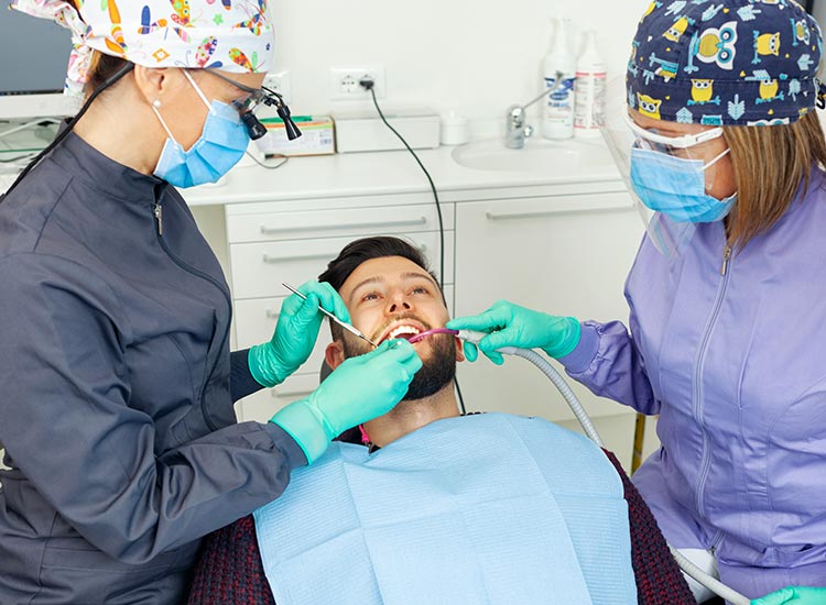 dentist and dental assistant working on a patient