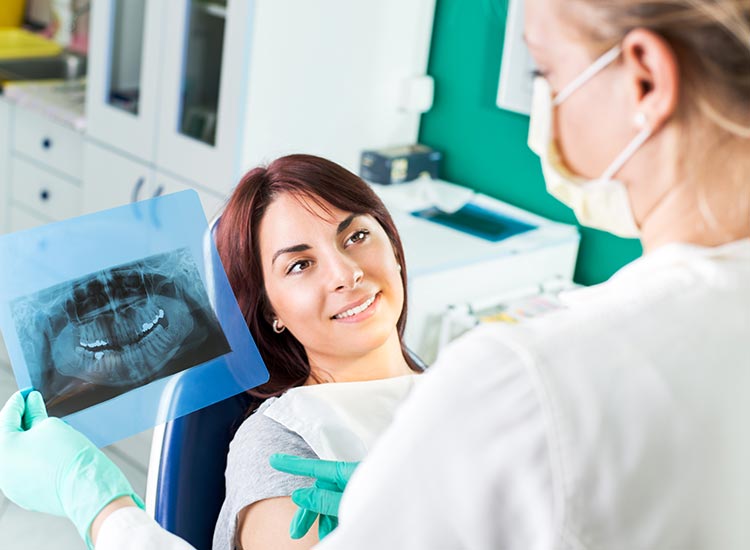 dentist examining patients x-ray