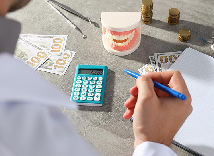 person calculating costs of dental work