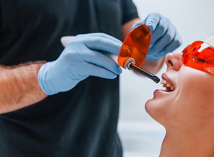 dentist using dental tools on patient