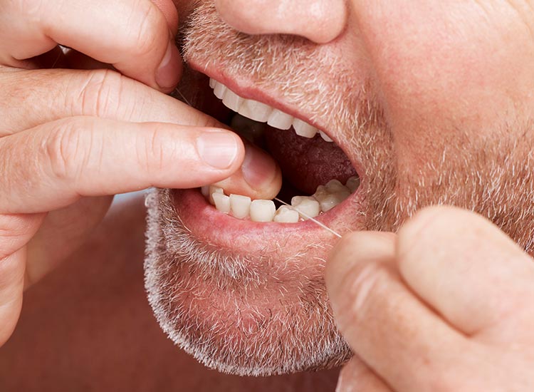 person flossing teeth