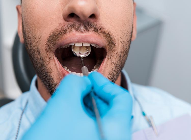 dentist checking patients teeth